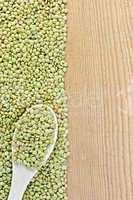 Lentils green on board on the left with spoon