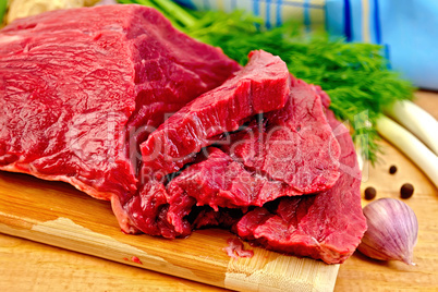 Meat beef with herbs on wooden board