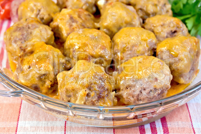 Meatballs with sauce in glass pan on tablecloth