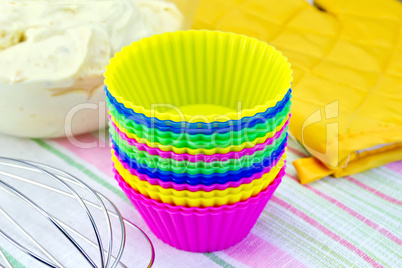 Molds for cupcakes with potholder mixer on fabric