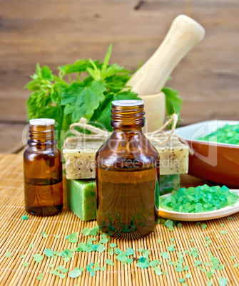 Oil and soap with nettles in mortar on board