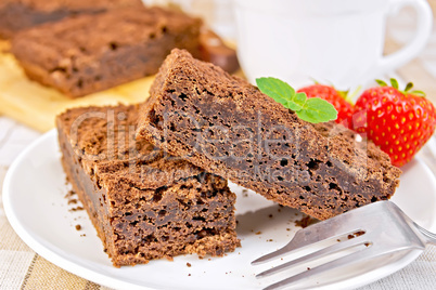 Pie chocolate with strawberries in plate on napkin