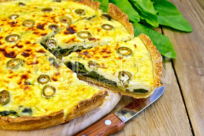 Pie with spinach and cheese on board