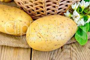 Potatoes yellow with flower and basket on board