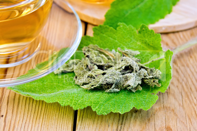 Sage dried on fresh leaf with cup on board