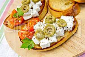 Sandwich with feta and olives on napkin