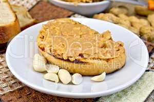 Sandwich with peanut butter and nuts in bowl on napkin