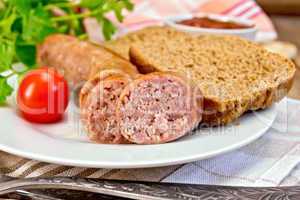 Sausages pork grilled in plate with bread on napkin