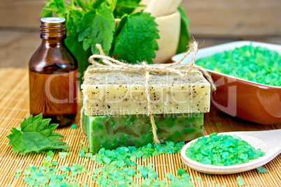 Soap homemade and oil with nettles in mortar on board