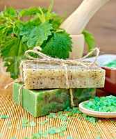 Soap homemade with nettles in mortar on board