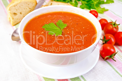 Soup tomato in bowl on linen napkin