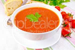 Soup tomato in bowl on linen napkin