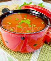 Soup tomato in red ware on napkin