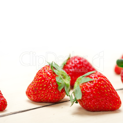 fresh organic strawberry over white wood