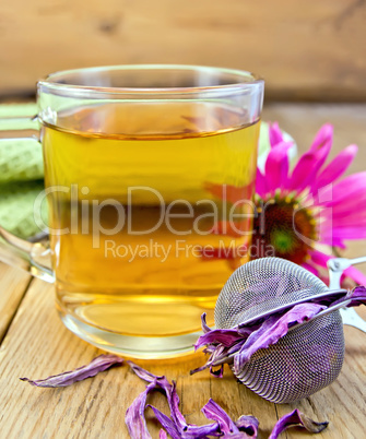 Tea from Echinacea in glass mug with strainer on board