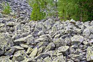 Stones with yellow mold at the foot of the mountain