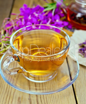 Tea from fireweed in glass cup on board