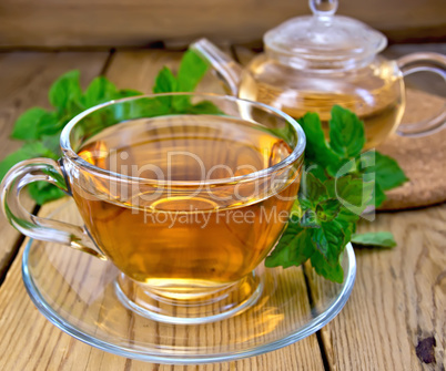 Tea with mint on wooden board