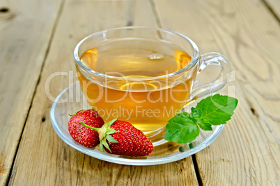 Tea with strawberries and mint on board