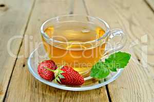 Tea with strawberries and mint on board
