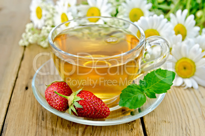Tea with strawberries and daisies on board