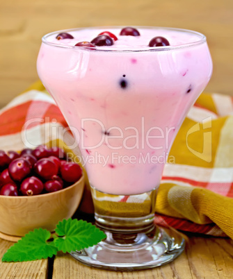 Yogurt thick with cranberries and napkin on board