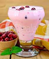 Yogurt thick with cranberries and napkin on board