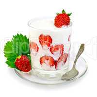 Yogurt thick with strawberries in glass and spoon