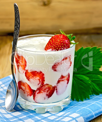 Yogurt thick with strawberries and leaves on board