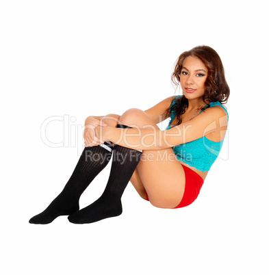 Young woman sitting on floor.