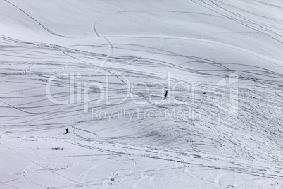 Silhouettes of snowboarders and skiers on off piste slope