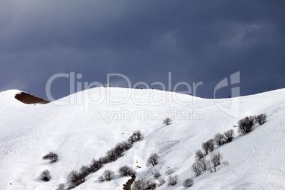 Off piste slope and overcast sky in windy day
