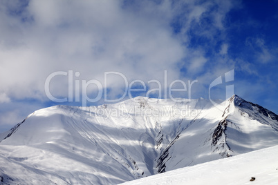 View on off-piste snowy slope in wind day