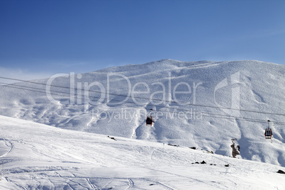 Gondola lifts and ski slope at nice sun day