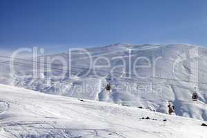 Gondola lifts and ski slope at nice sun day