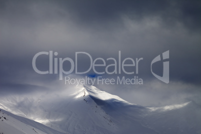 View on off-piste slope in storm clouds