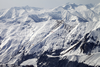 Paragliders of snowy mountains