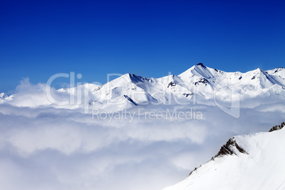 Winter snowy mountains under clouds at nice day