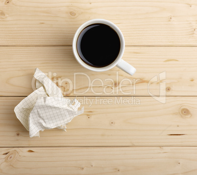 cup of coffee and crumpled paper