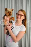 Girl holding Yorky dog