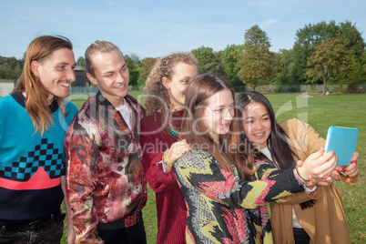 Adults young people look at the park on tablet computer