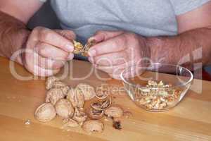 Man opens walnuts
