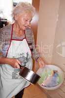 Woman in kitchen with carp fillets