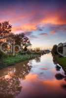 Wonderful sunset colors of fall with river reflections