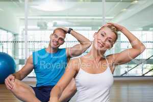 Couple stretching necks in yoga class
