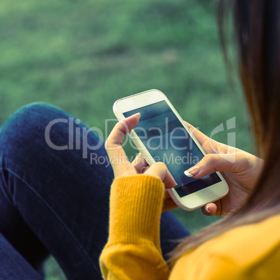 Woman text messaging in park