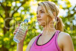 Fit blonde holding her water bottle