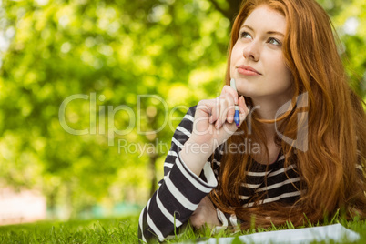 Female student doing homework in park