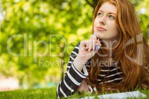 Female student doing homework in park