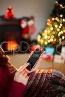 Woman using her mobile phone at christmas